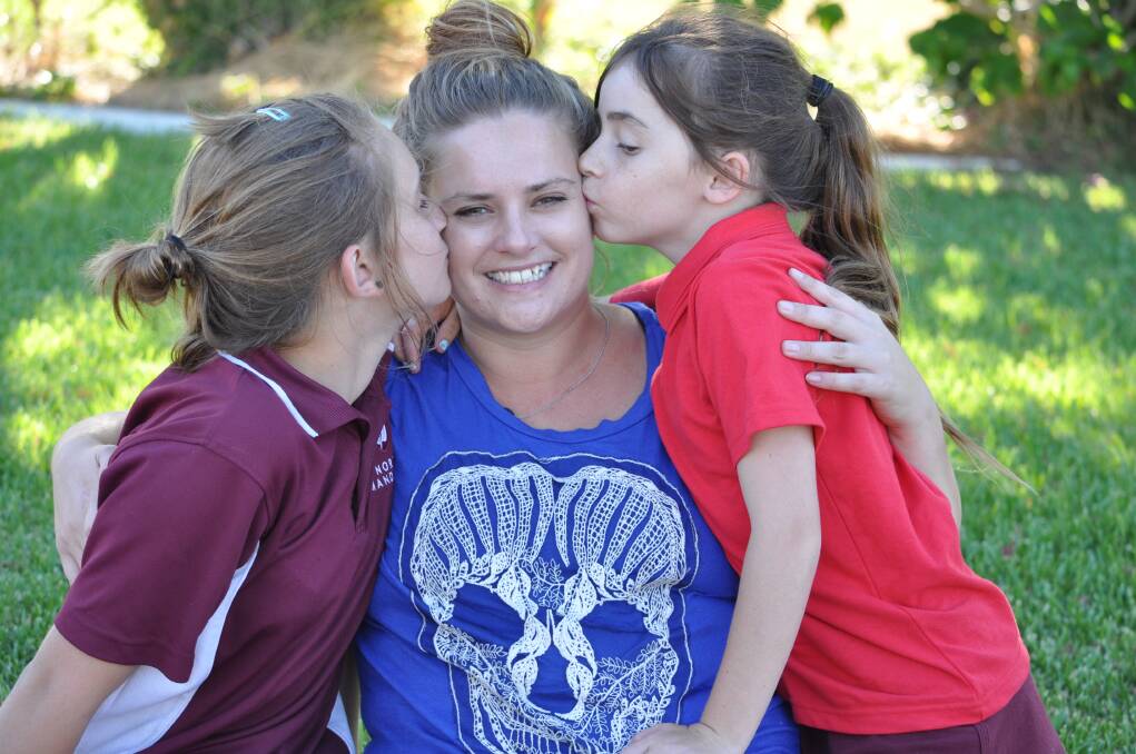 Christie McCann holds her girls tight following last Friday's attempted abduction.