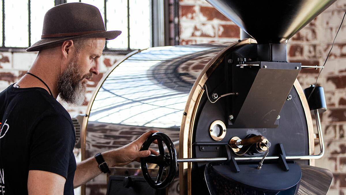 COFFEE GURU: Purri Gould roasts the coffee at Groundswell Drivethru in a 15kg wood-fired roaster. Photo: Air Creative.