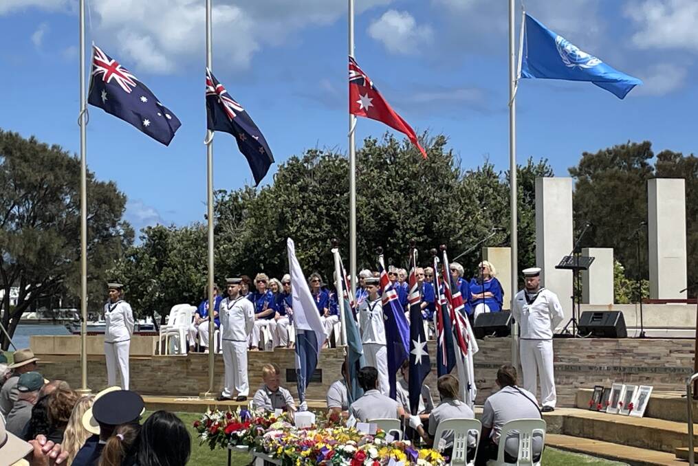 The flags of Australia, New Zealand, the Australian Red Ensign and the United Nations fly at half mast at the Mandurah Remembrance Day Service at Mandurah War Memorial.